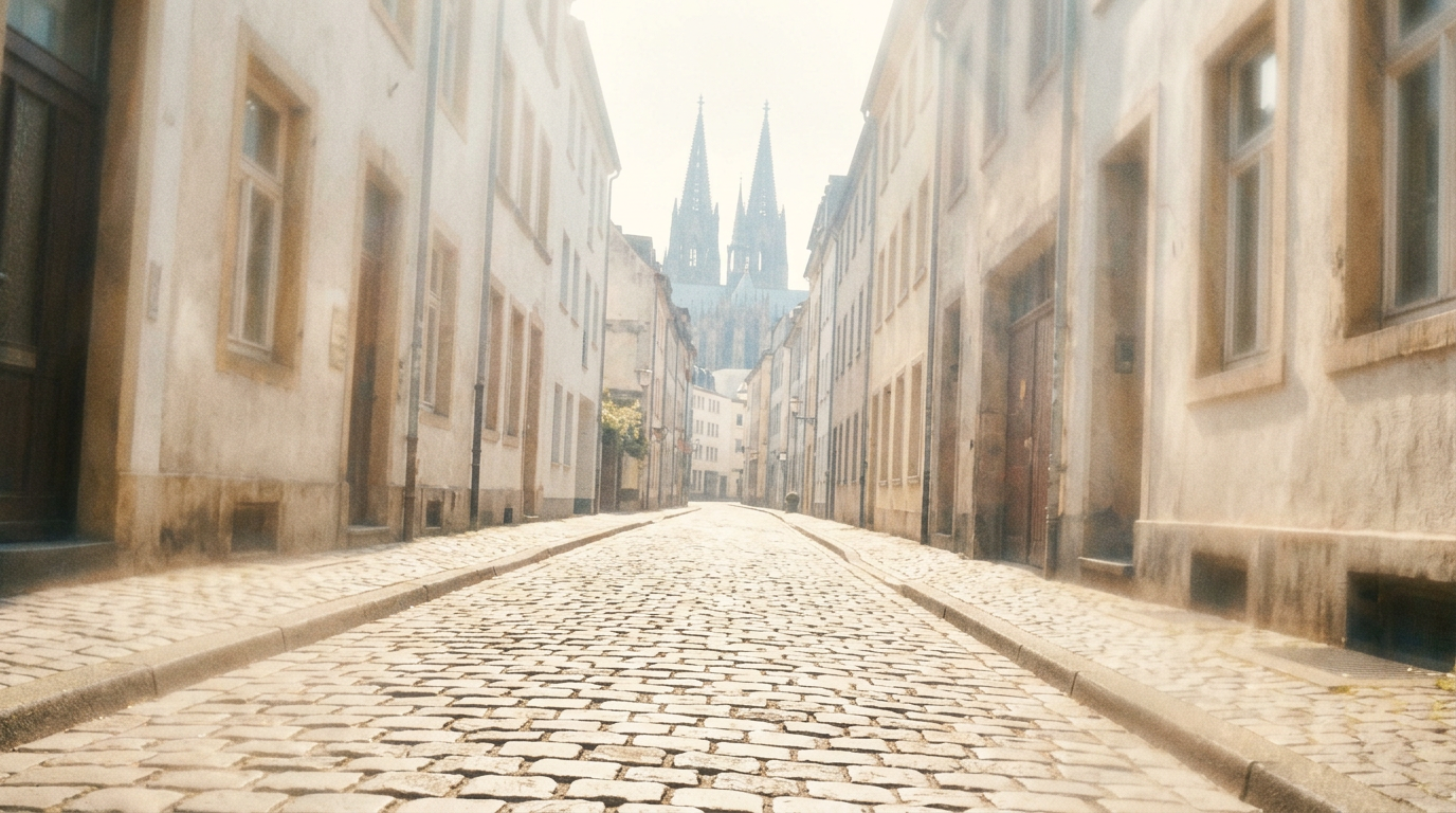An illustration of a quiet cobbled street with cathedral spires in the distance.